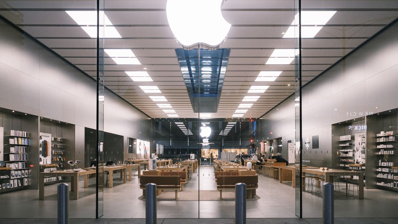 services-02 Explore the minimalist design of a modern tech store interior, showcasing a bright, elegant layout.